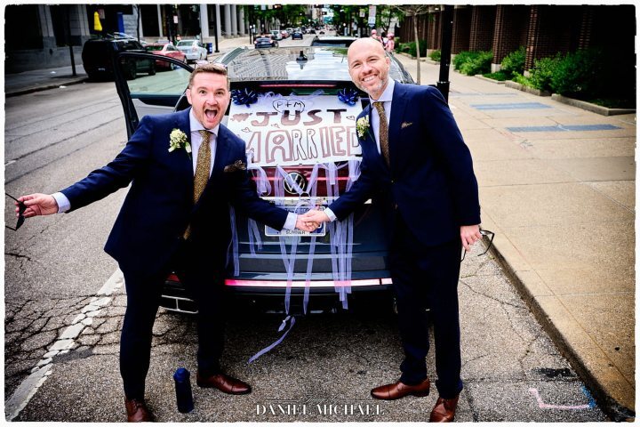 LGBTQ+ Wedding Photo with their Decorated Just Married Car